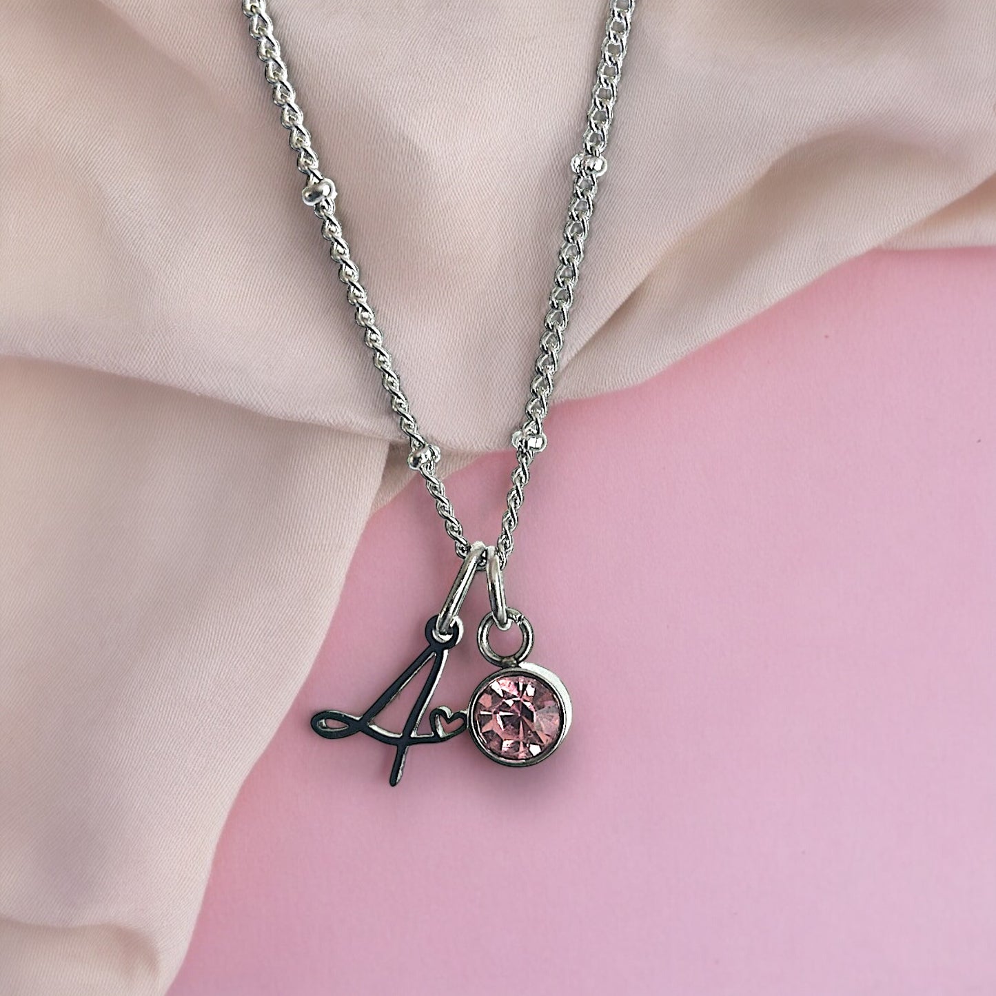 Cursive Initial necklace with heart detail in silver tone water and tarnish resistant