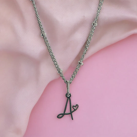 Cursive Initial necklace with heart detail in silver tone water and tarnish resistant